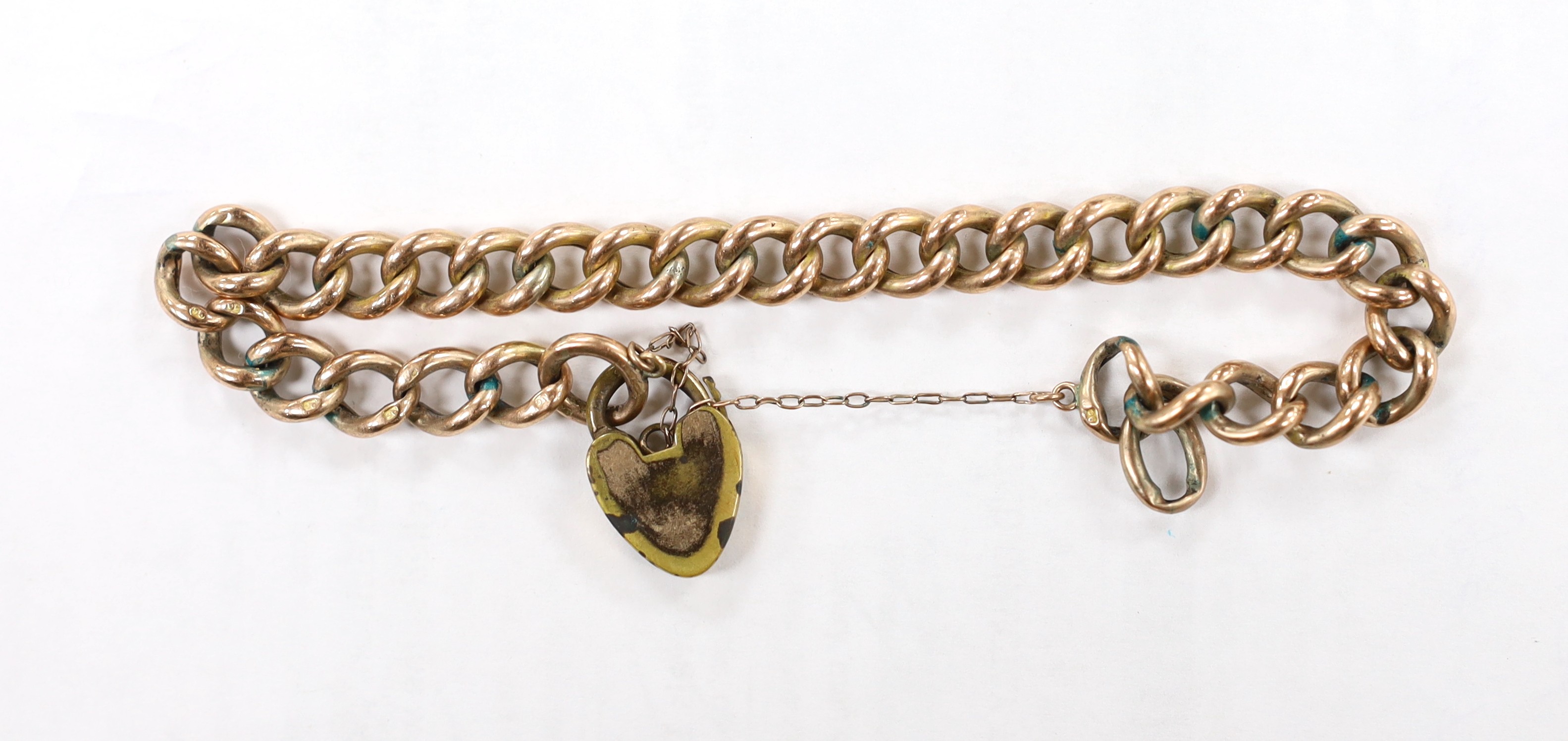 A 9ct curb link bracelet with gold plated heart shaped padlock clasp, 19.5cm, gross weight 10.8 grams.